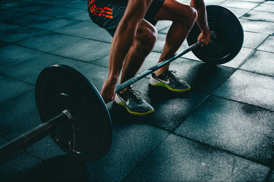 a man lifts a barbell in a gym – BUILT Bar