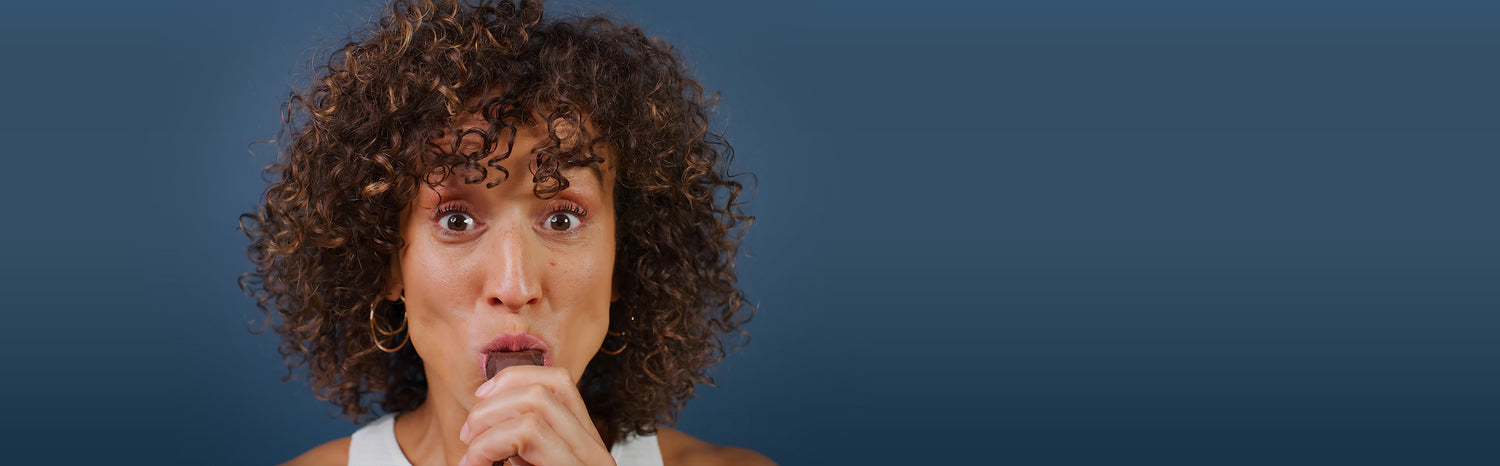 Woman enjoying a BUILT protein bar
