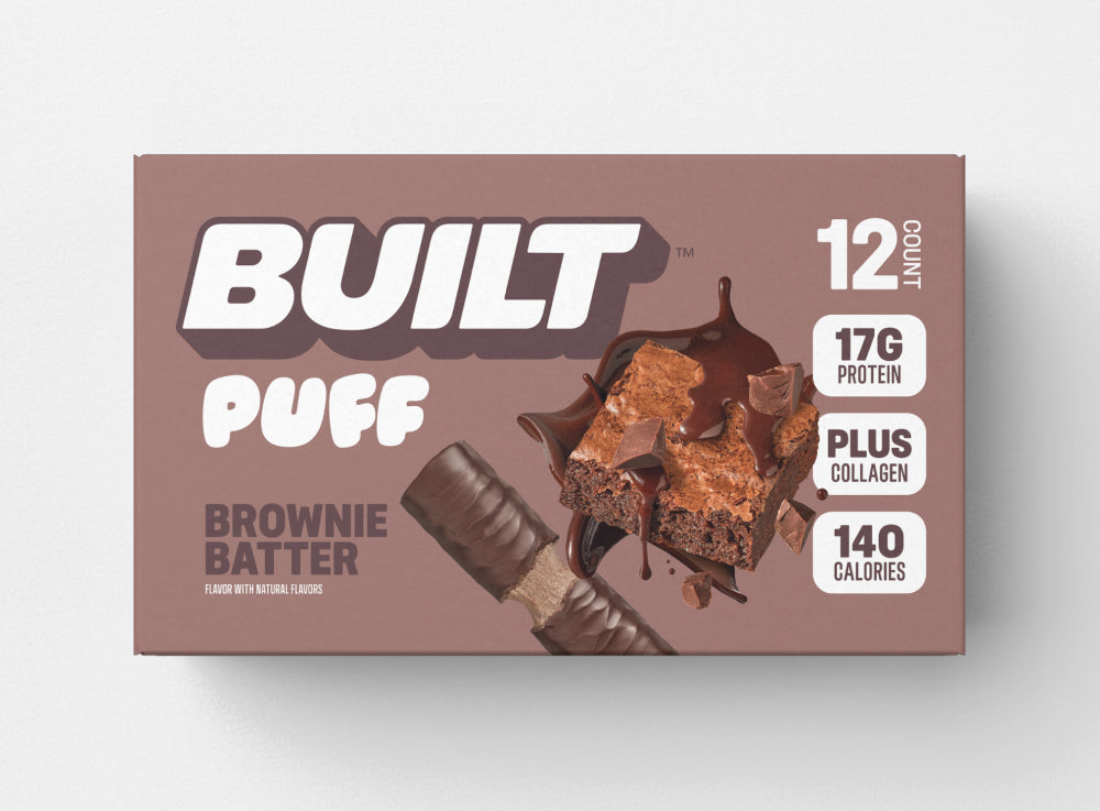 A 12 count, light brown box of BUILT brownie batter puffs on a white background.