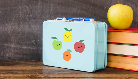 blue rectangular metal lunchbox with cartoon fruits on the front.