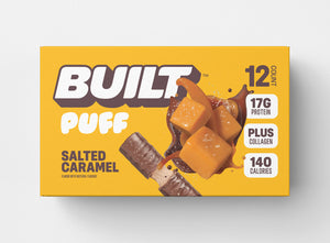 A yellow box of 12 BUILT salted caramel puffs on a white background.