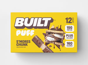 A yellow box of 12 BUILT s'mores chunk puffs on a white background.