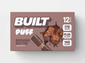 A 12 count, light brown box of BUILT brownie batter puffs on a white background.